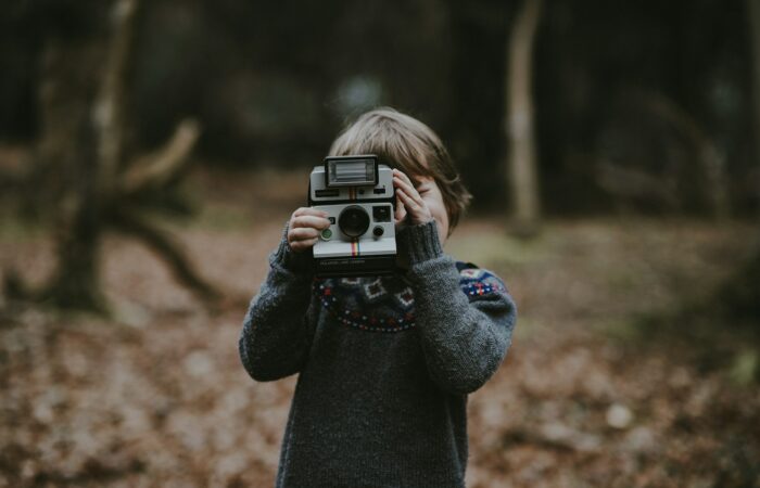 kid holding camera