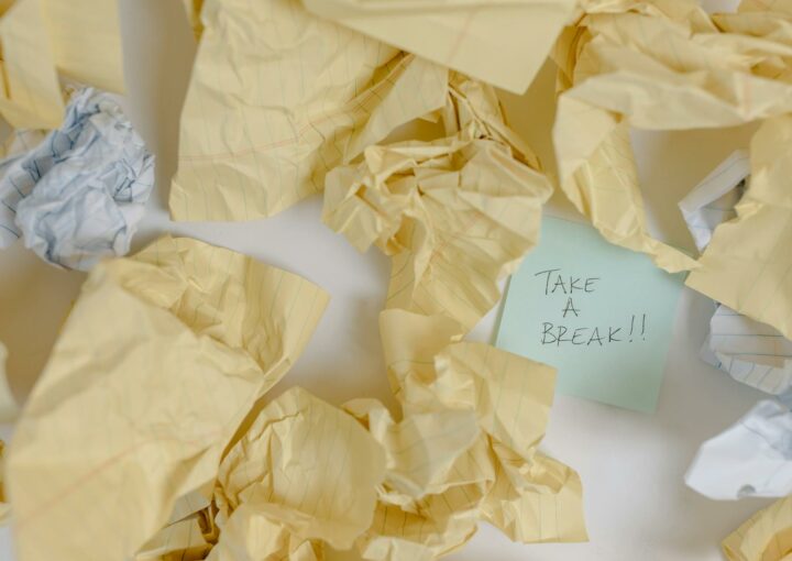 Crumpled papers scattered around with a note reading 'Take a Break'.