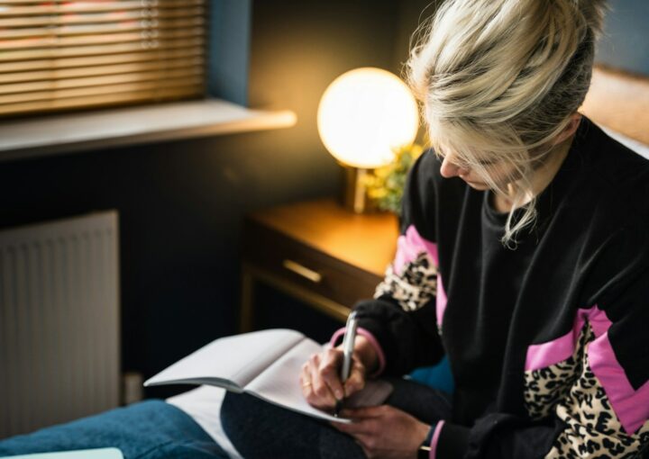 woman in black and white long sleeve shirt sitting on bed