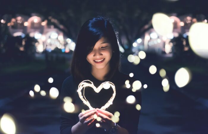 A woman holding a heart