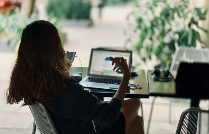 woman sitting on chair in front of table with laptop