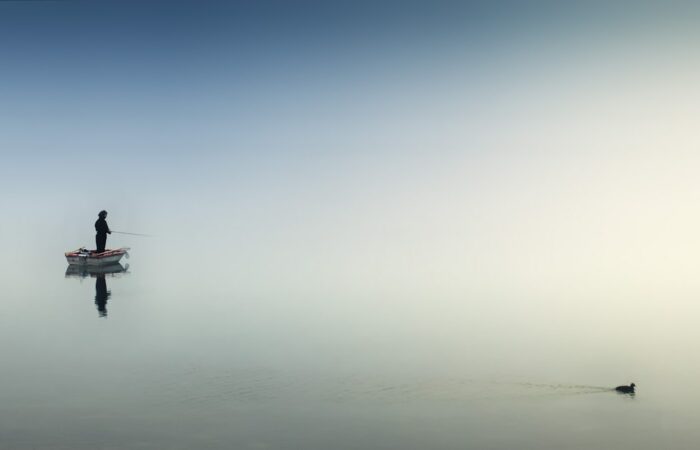 rule of thirds photography of man on boat