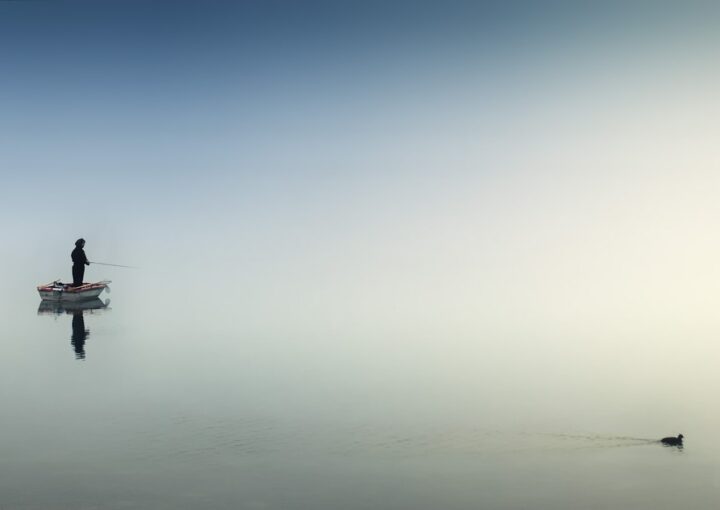 rule of thirds photography of man on boat