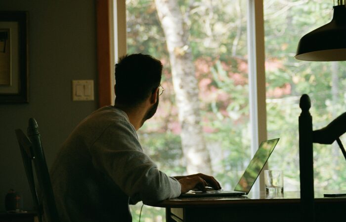 man in gray hoodie using laptop computer