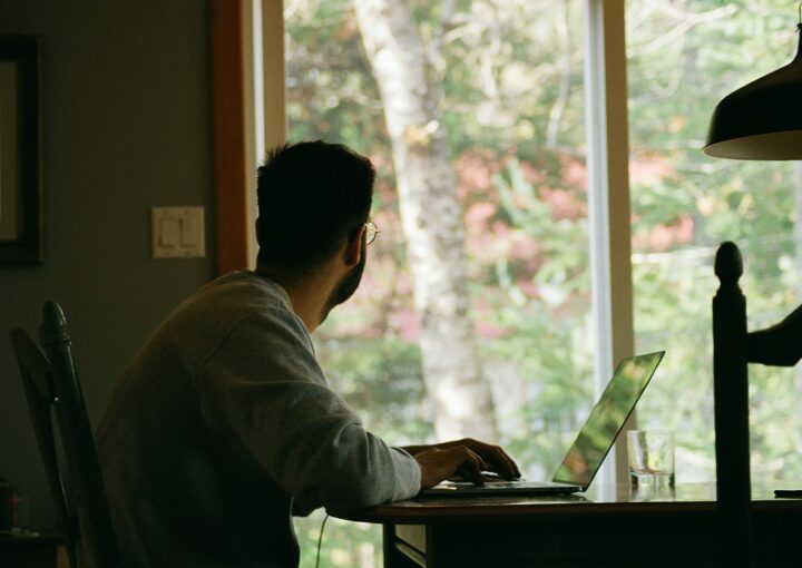 man in gray hoodie using laptop computer