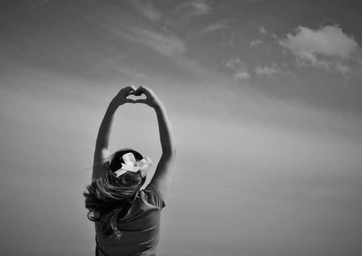 woman making heart shape on her hards