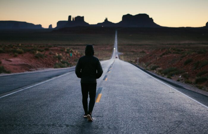 person walking in the center of the road