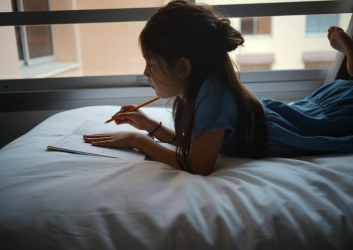 a woman writing on a book