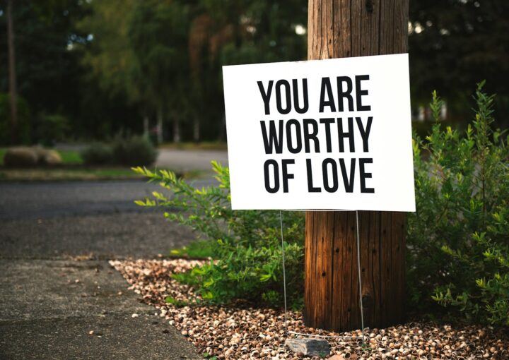 you are worthy of love sign beside tree and road